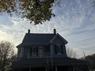 Completed dark roof on a two-story home