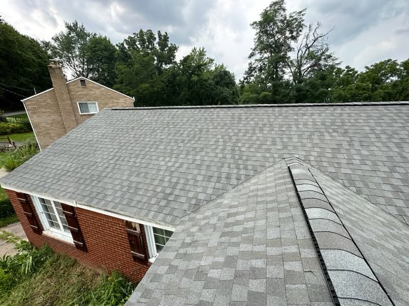 Close view of completed architectural shingles and ridge caps