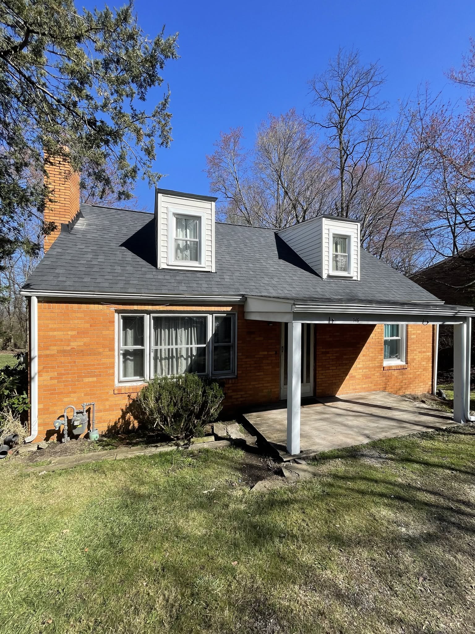 Completed charcoal shingle roof with dormer windows