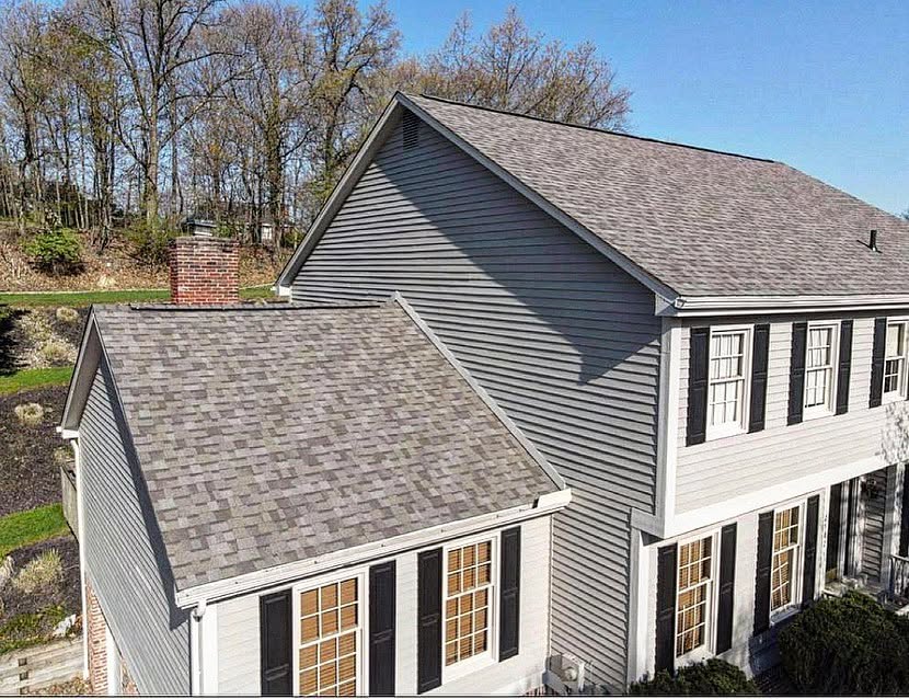 Completed gray shingle roof on a multi-level home