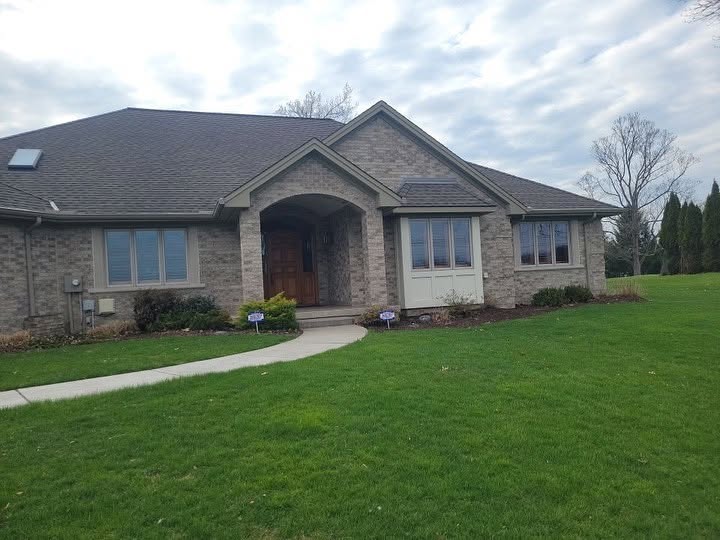 Completed residential roof on a brick home